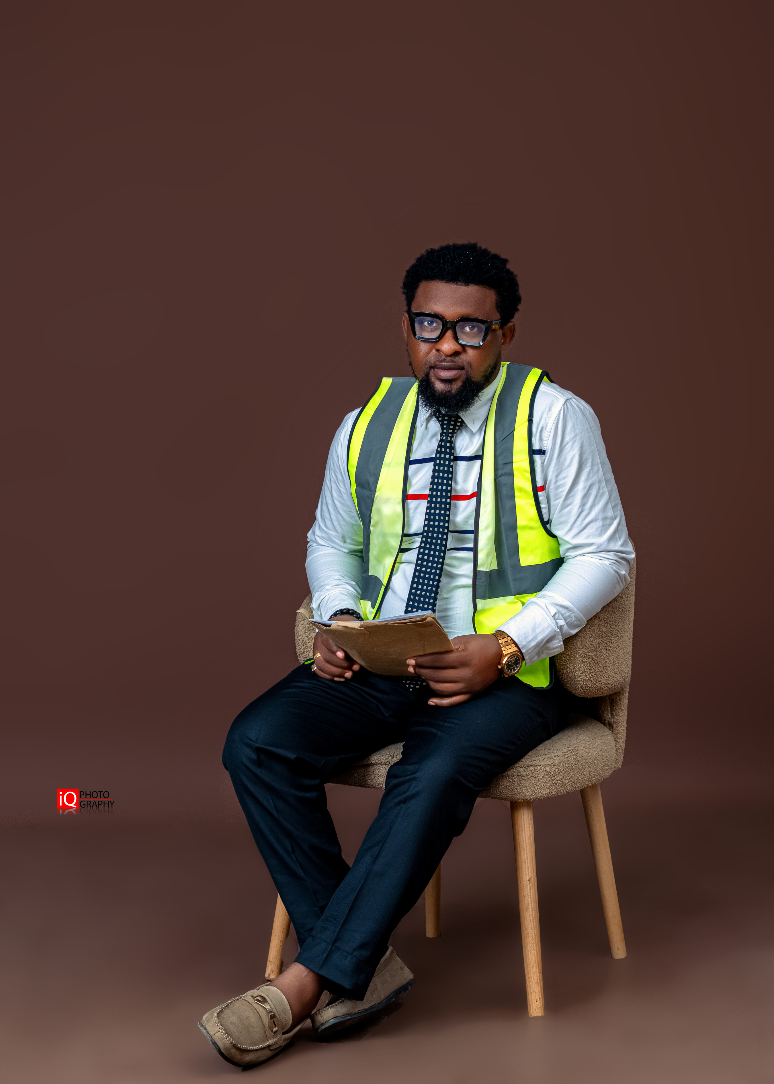 Engr. Joseph Oluwaseun Adebayo seated in construction safety vest